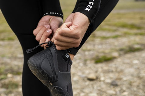 ION Plasma Shoes 2.5 neoprene boots during kitesurfing session preparation on rocky Icelandic coast