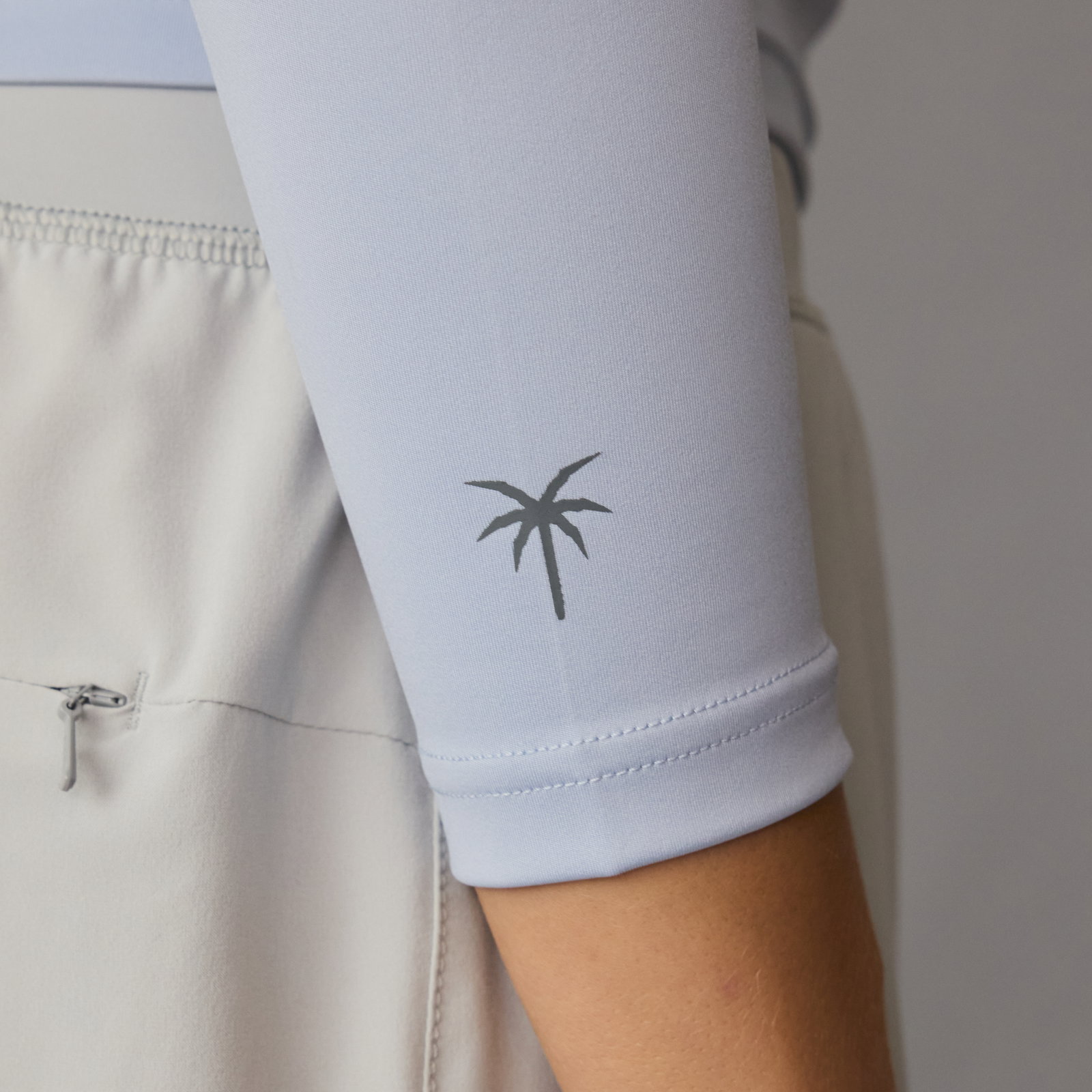 ION Rashguard LS women long sleeve top in misty grey — sleeve detail with palm tree print