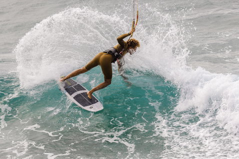 ION Seek Core 3/2mm front-zip shorty wetsuit in olive green during wave riding on the ocean