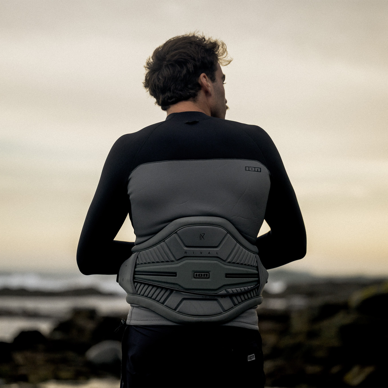 ION Rival waist harness in sage grey with EVA back plate during kitesurfing at the coast