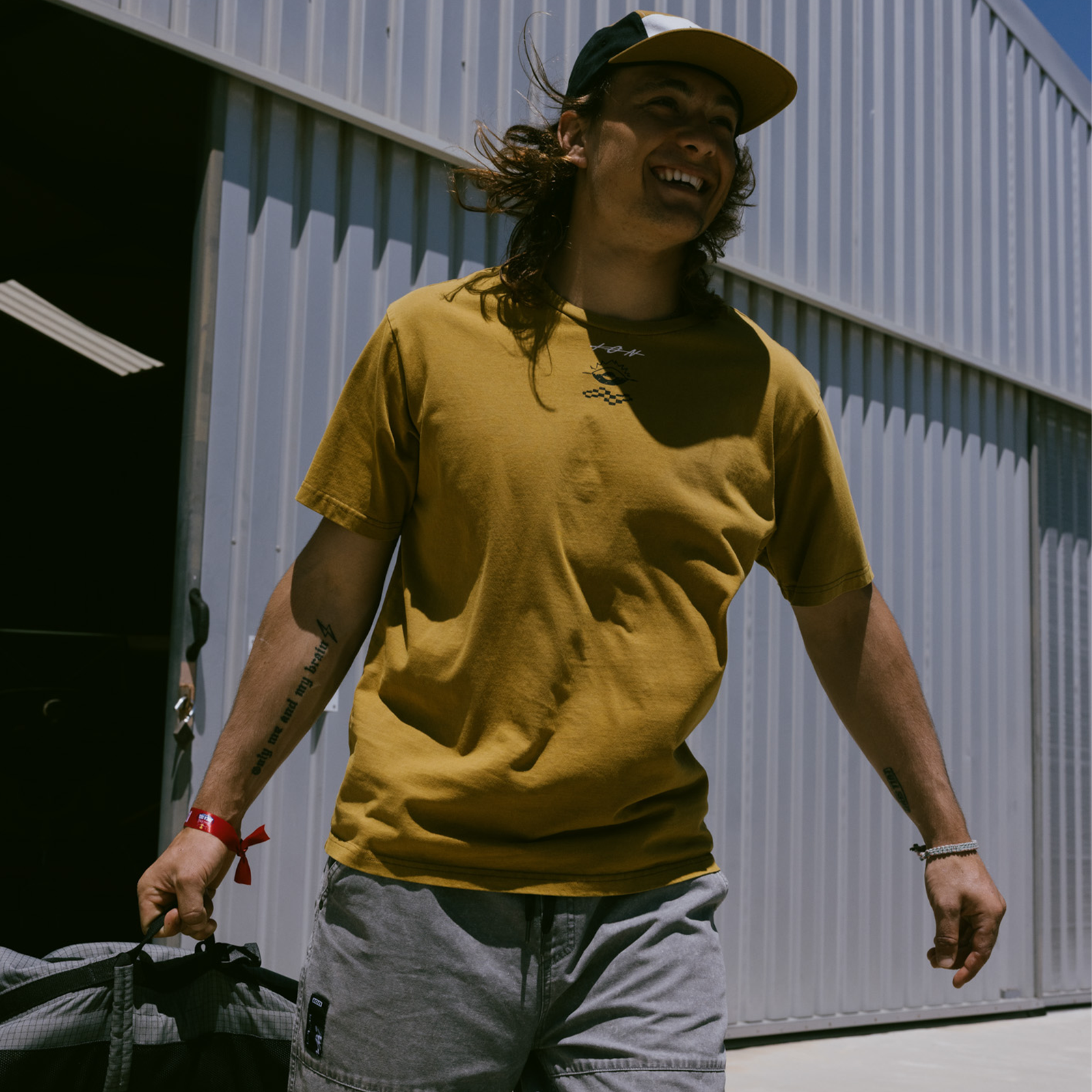 ION Mood SS men's T-shirt in goldburst worn outdoors on a sunny day