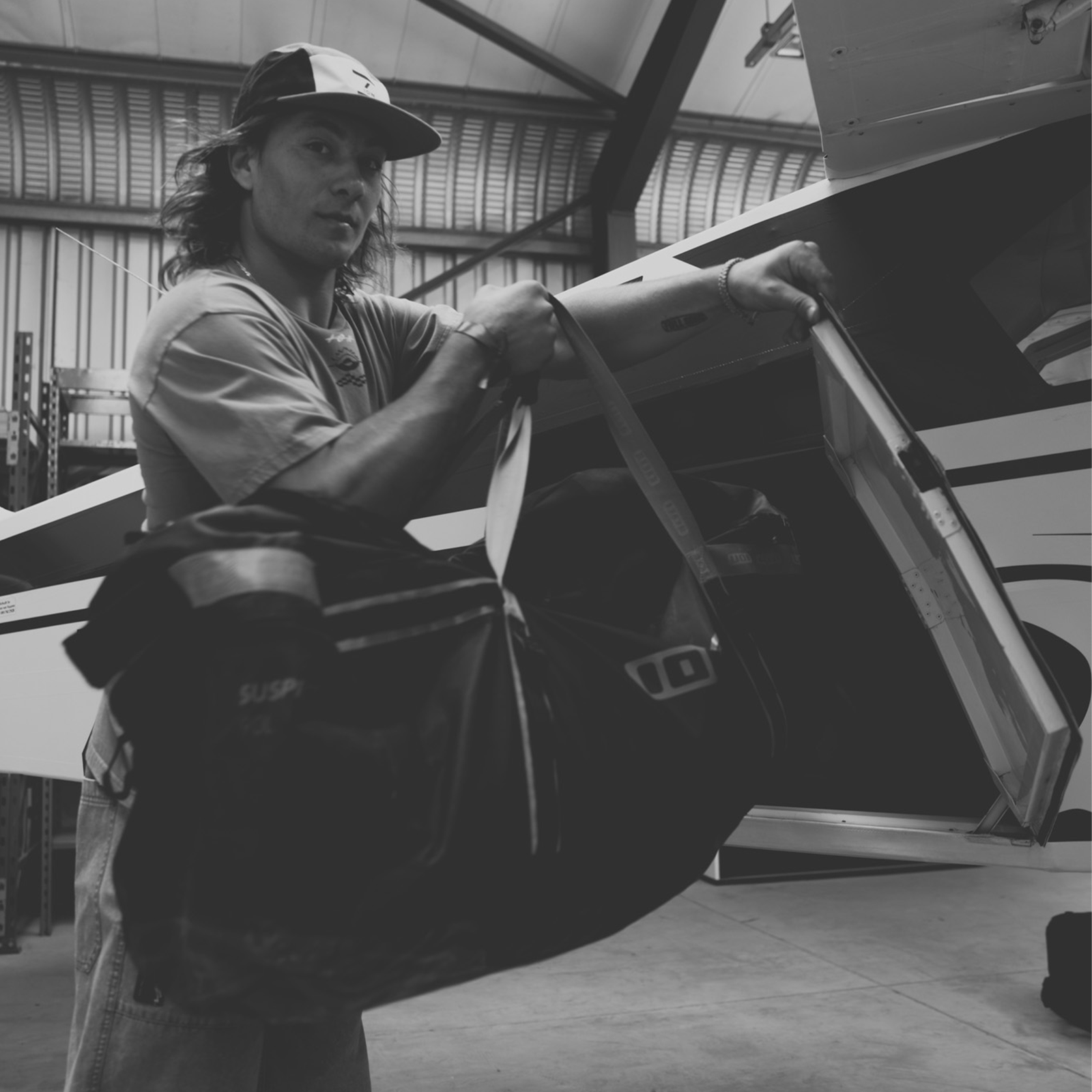 ION Suspect Duffel Bag 90l during travel inside an aircraft hangar