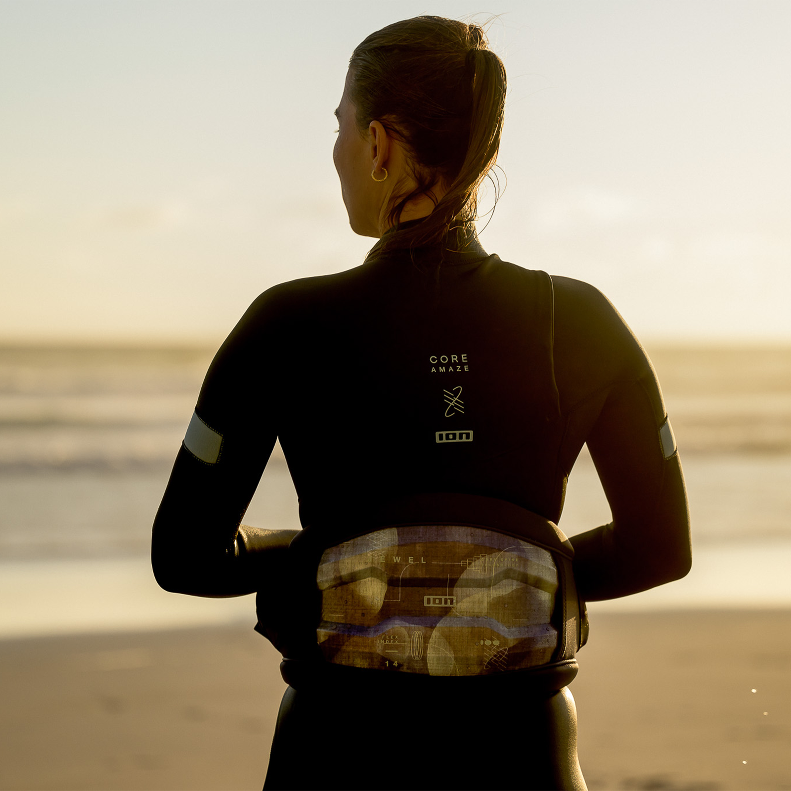 ION Jewel Curv women's waist harness in deep sea during windsurfing at the beach