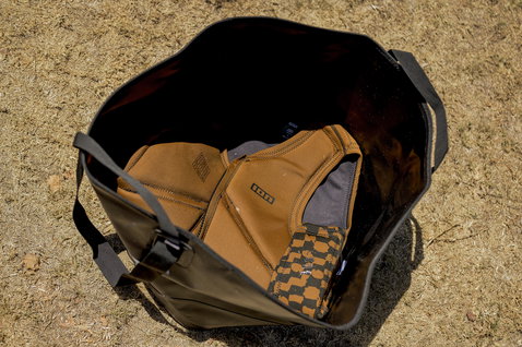 ION Changing Bucket bag Onesize in black with tan neoprene contents top-down interior view