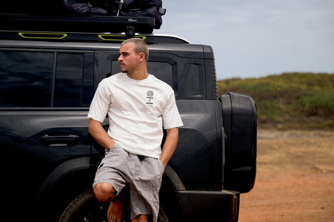 ION Vibes SS men's t-shirt in white, worn by a model at a coastal outdoor location