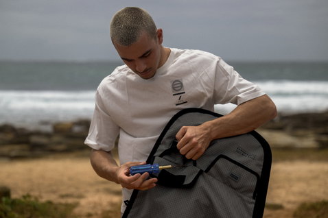 ION Core twin-tip kiteboard bag during kitesurfing preparation at the ocean beach