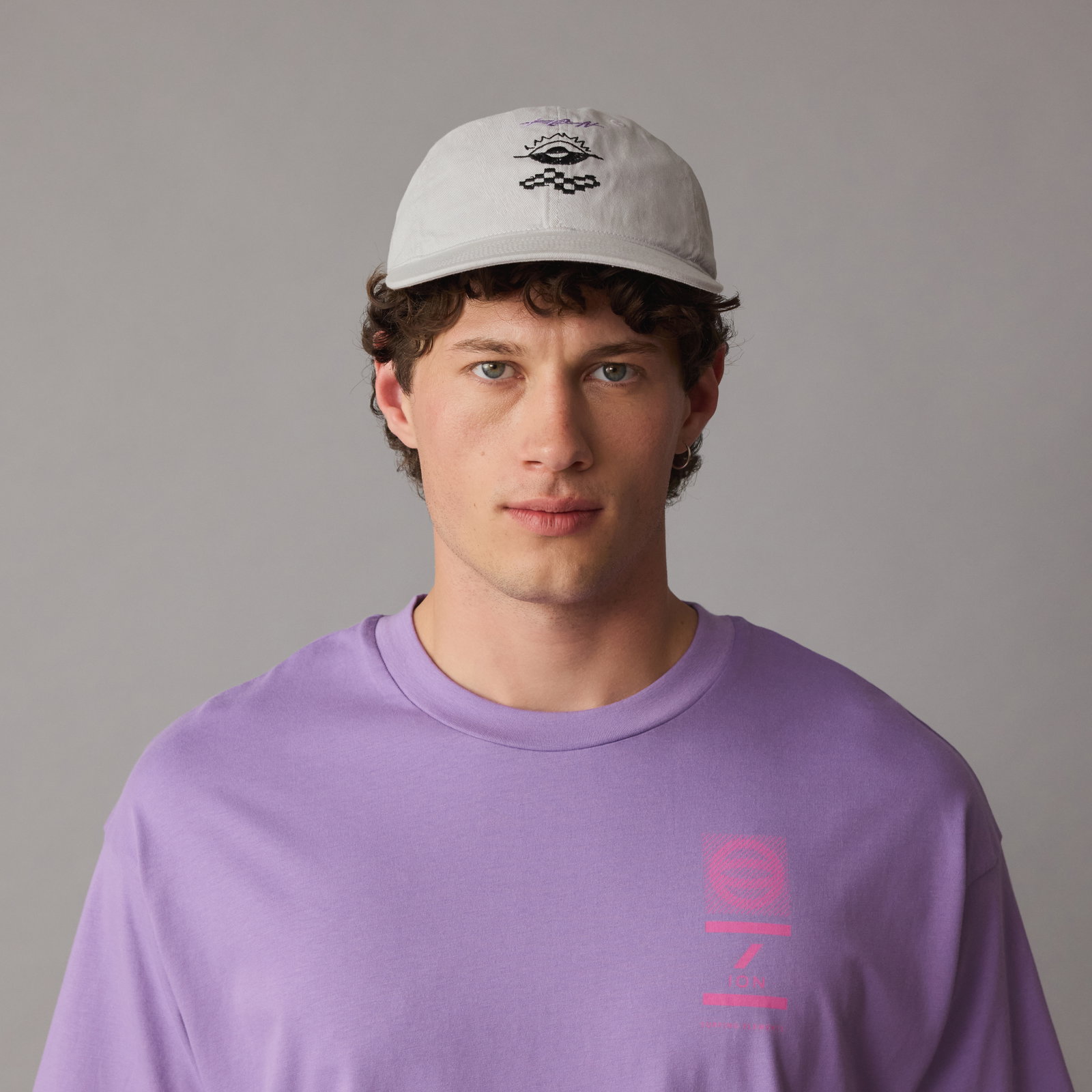 ION Cap Team in frosted grey with embroidered logo worn by male model in studio