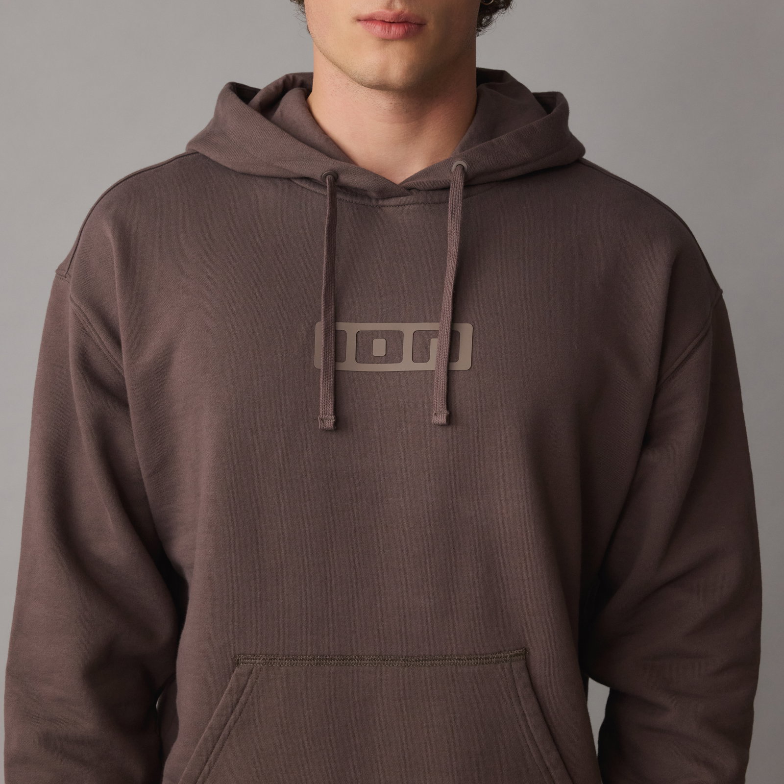ION Ionic men's hoodie in driftwood with tonal logo print, on-model detail shot