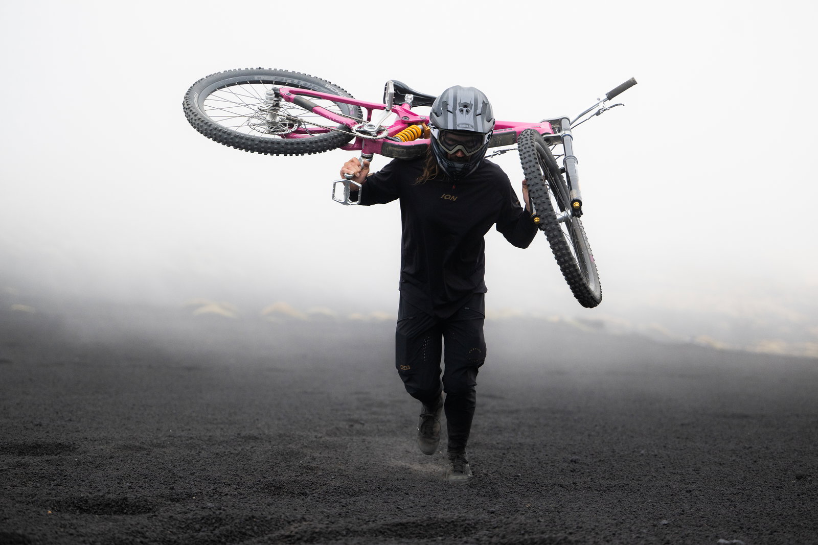 ION Bike Scrub pants unisex in black during mountain biking in misty volcanic terrain