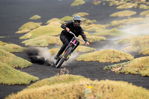 ION Bike Scrub LS long-sleeve jersey in black during mountain biking on volcanic terrain