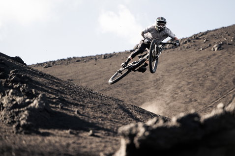 ION Ionic SS Merino cycling jersey men in light grey during mountain biking on volcanic terrain