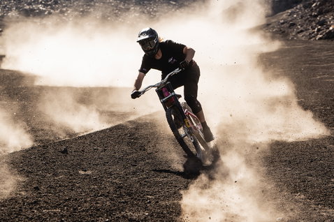 ION Ionic SS Merino cycling jersey men in black during mountain biking on dusty volcanic trail