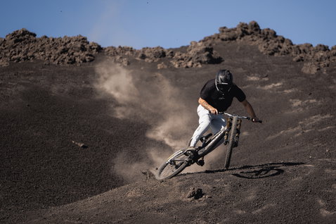 ION Ionic SS DR Lyocell short-sleeve cycling jersey in black during mountain biking on volcanic terrain