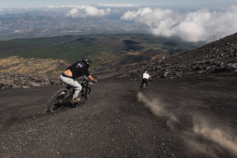 ION Bike Ionic SS DR Lyocell short-sleeve jersey in black during mountain biking on a volcanic mountain trail