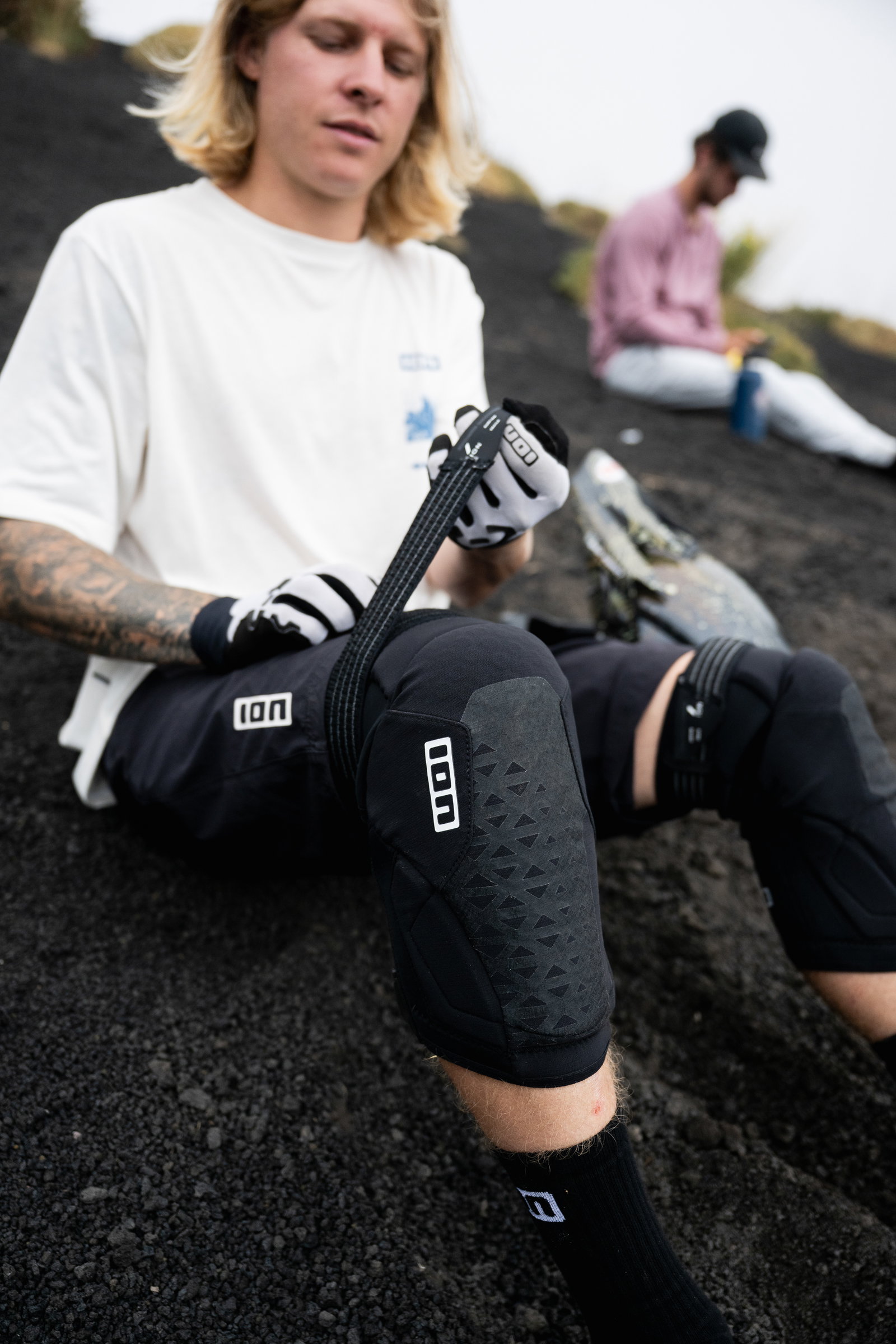 ION K-Pact Zip knee pads in black during mountain biking on volcanic terrain