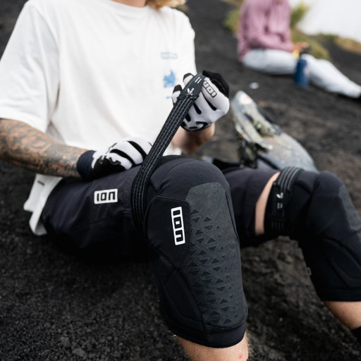 ION K-Pact Zip knee pads in black during mountain biking on volcanic terrain