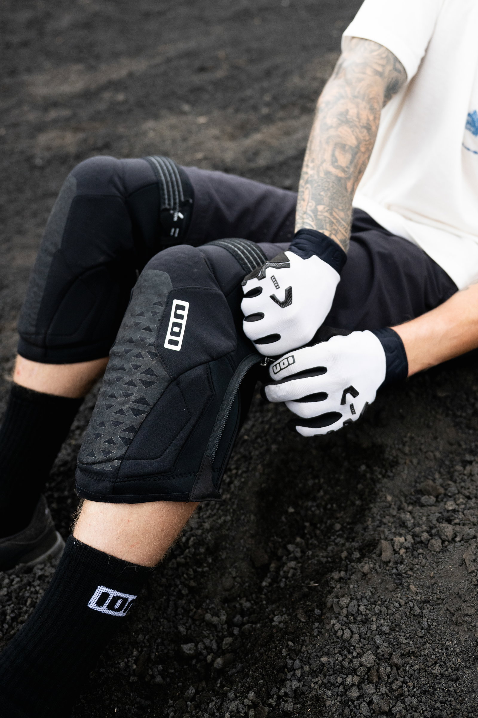 ION K-Pact Zip knee pads in black during mountain biking on rocky trail