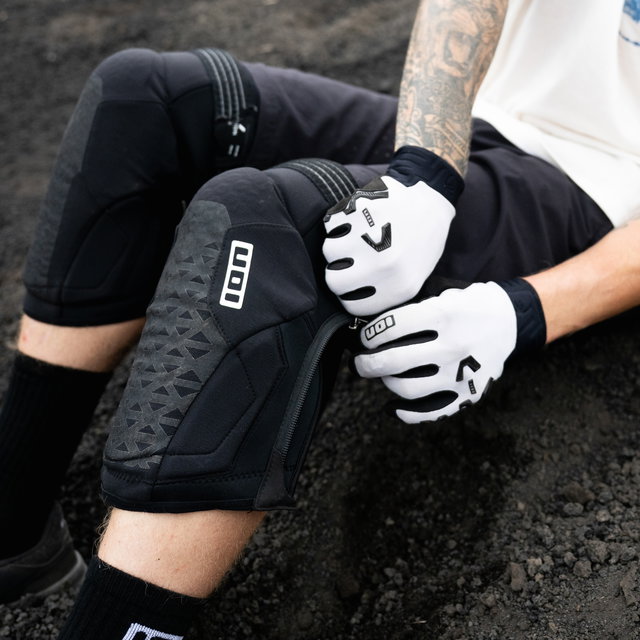 ION K-Pact Zip knee pads in black during mountain biking on rocky trail