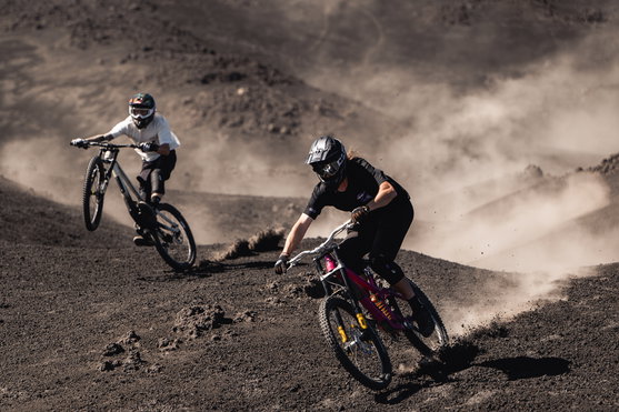 ION K-Pact Zip knee pads during mountain biking on a volcanic trail in black