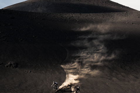 ION Bike K-Pact knee pads during mountain biking descent on dramatic volcanic terrain