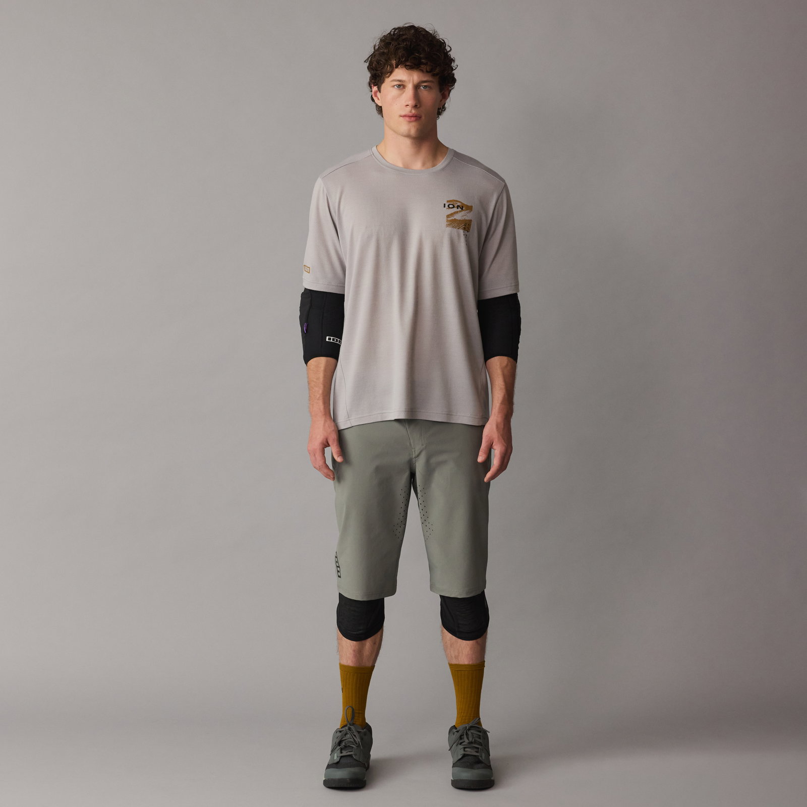 ION E-Pact elbow pads in black worn on-model with full MTB outfit in studio