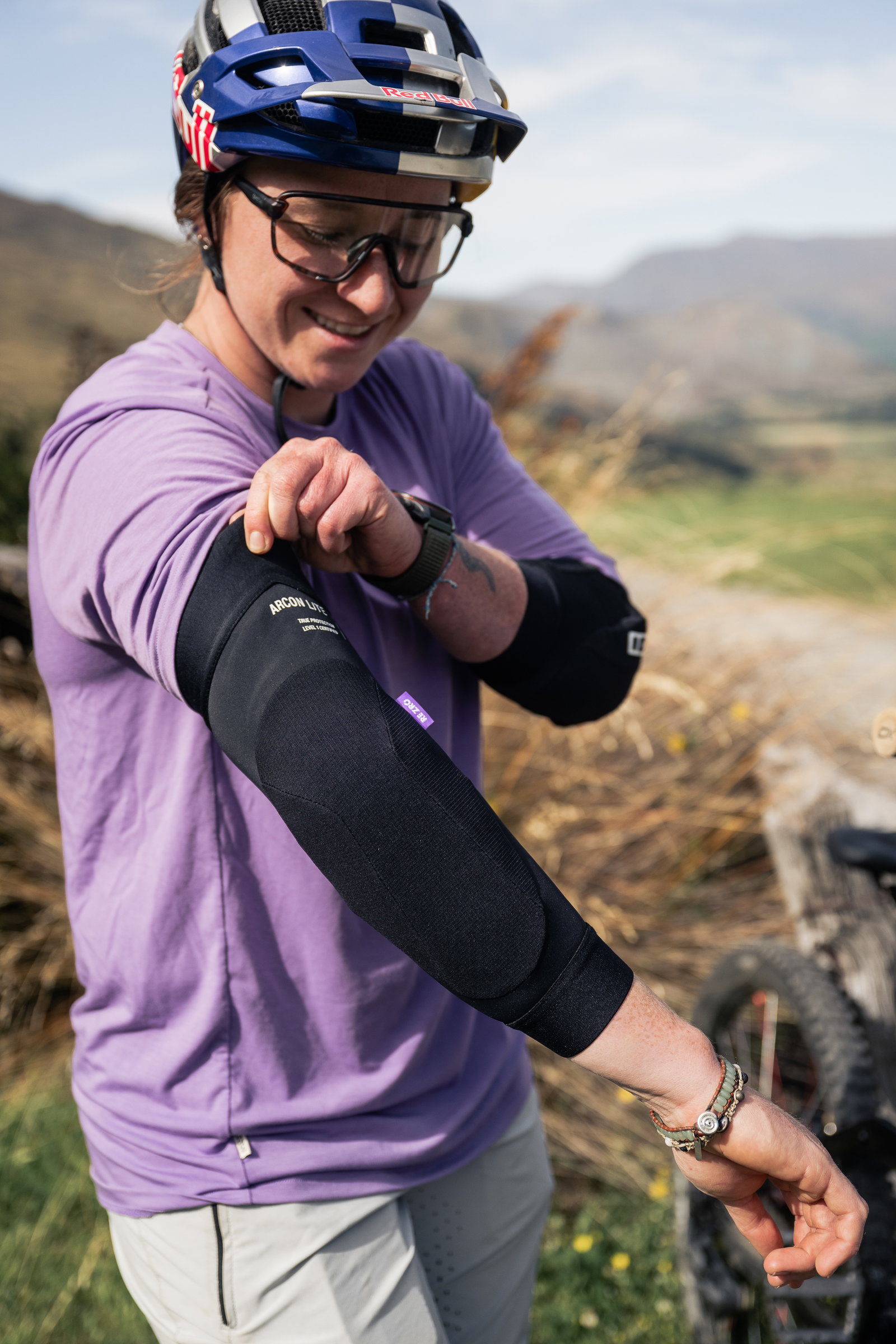 ION Bike ARCON LT elbow guard in black during mountain biking on a trail