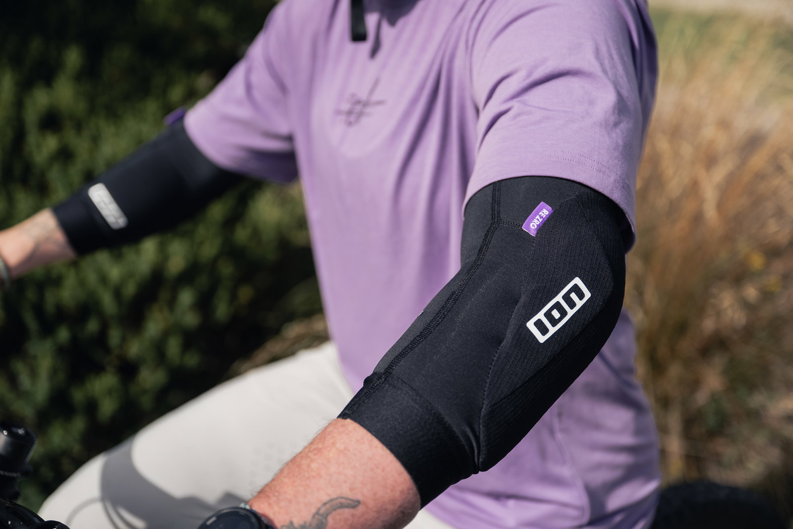 ION ARCON LT elbow guard in black during mountain biking outdoors