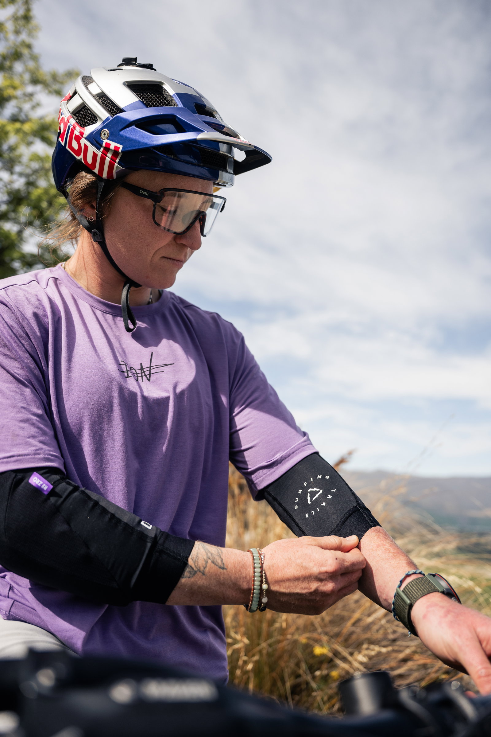 ION ARCON LT elbow guard with CE Level 2 RE ZRO protection during mountain biking on a hillside trail