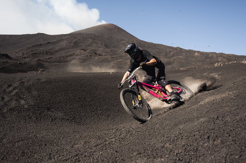 ION Bike Scrub Shorts in charcoal during mountain biking on volcanic terrain