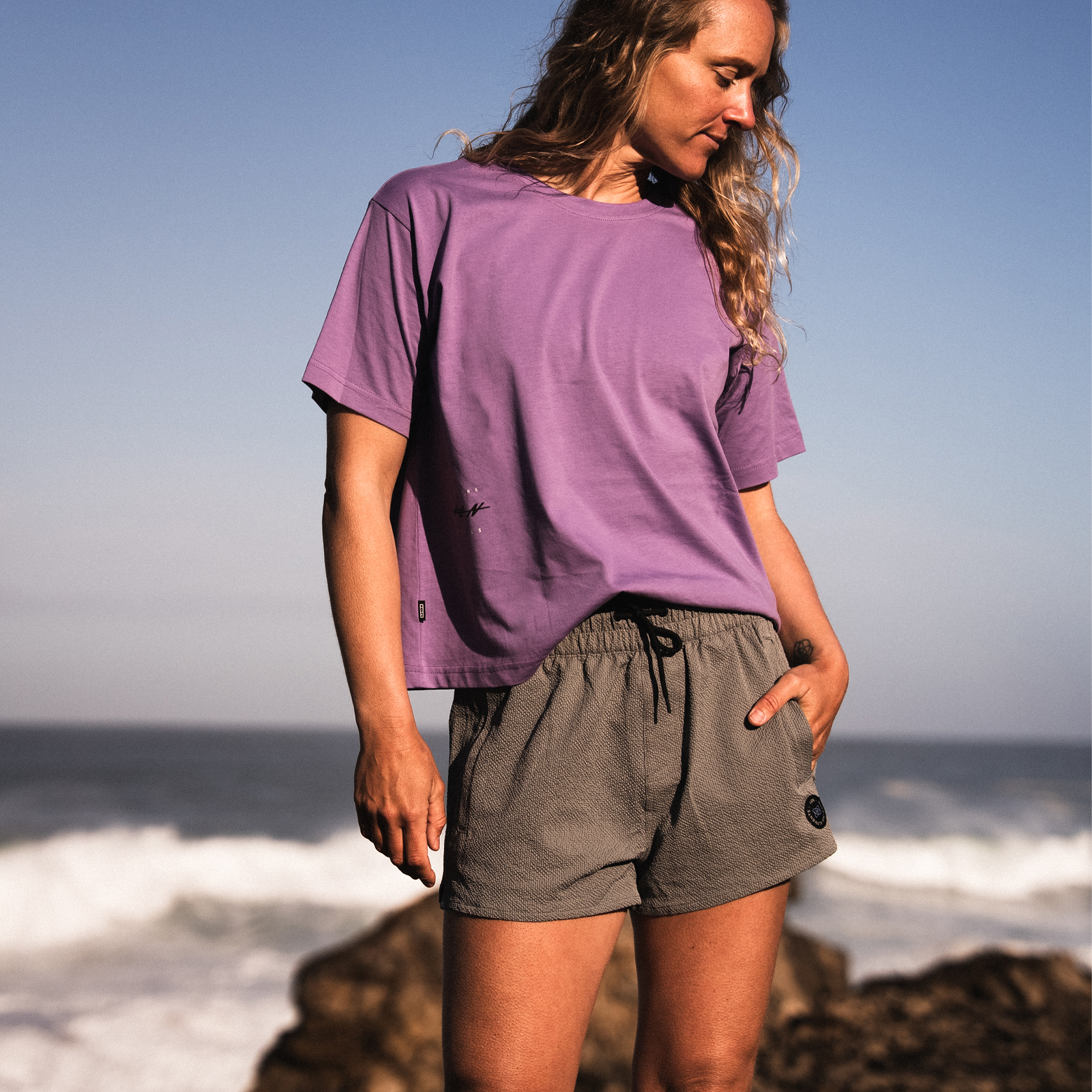 ION Tally women's boardshorts 2.5" in dark olive grey worn at the coast