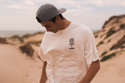 ION Vibes SS men's t-shirt in white worn on a beach among sand dunes