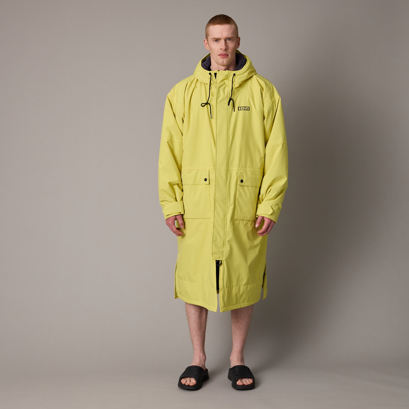 ION Storm Coat unisex water jacket in lime yellow with hood, front view on model
