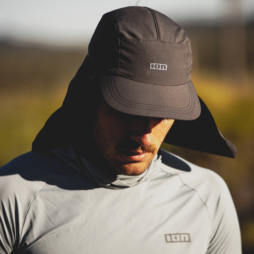 ION Surf Cap PRO cap in blue nights with neck flap worn outdoors in natural light