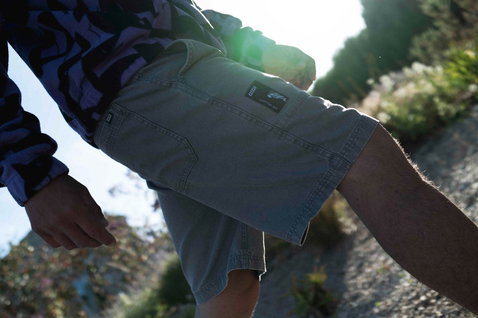 ION HD Cotton shorts in stone grey worn during a walk on a sunny coastal path