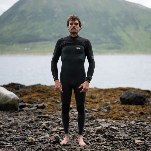 ION Seek Amp 5/4mm front-zip fullsuit wetsuit in black — men's on-model coastal lifestyle shot