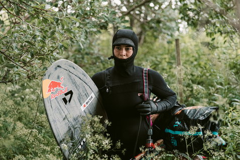 ION Amaze Amp 6/5mm hooded front-zip fullsuit in black during wave riding