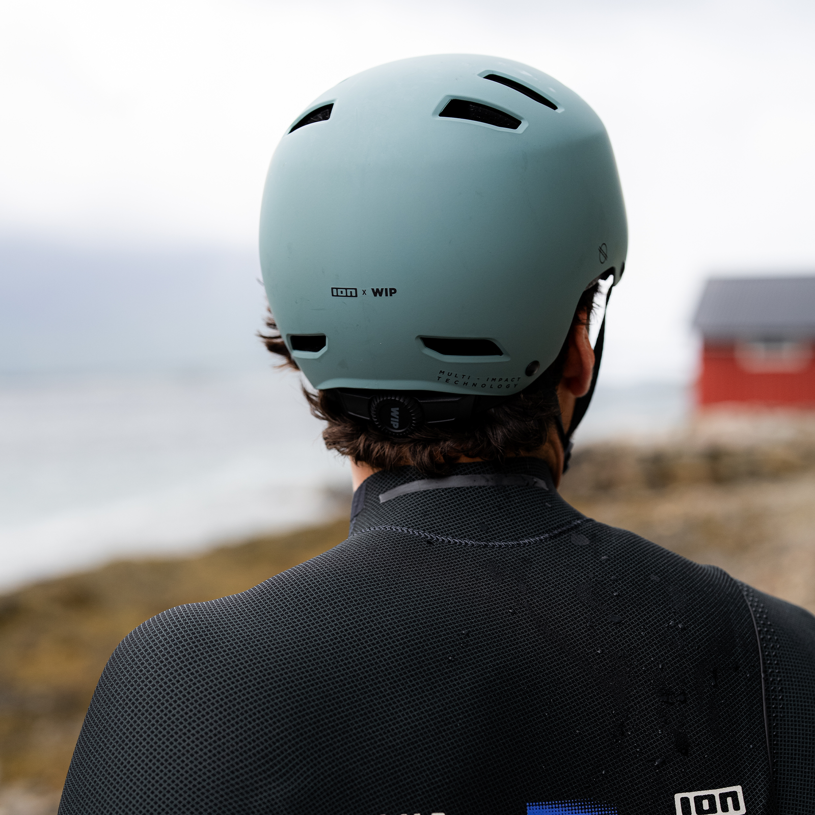 ION Slash Core helmet in sage worn during kitesurfing at the coast