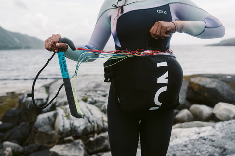 ION Jam waist harness in black during wing foiling at the coast
