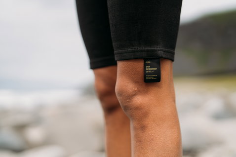ION Surf Shield bottom tights short in black showing cut-resistant level 4 certification label at hem